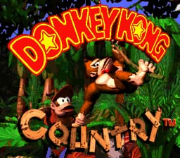 The title screen displays "Donkey Kong Country" in large red and yellow uppercase letters at the top, with "Competition" in smaller text below. Donkey Kong, rendered as a brown sprite with a red tie, sits prominently in the center-right of the image. Diddy Kong, a smaller tan-colored character, appears to the left. Both characters are positioned among stylized jungle foliage rendered in greens and browns, with a dark background. The overall color palette is vibrant with reds, yellows, greens, and browns typical of 16-bit SNES graphics, featuring distinct pixelated sprite work against detailed background vegetation.
