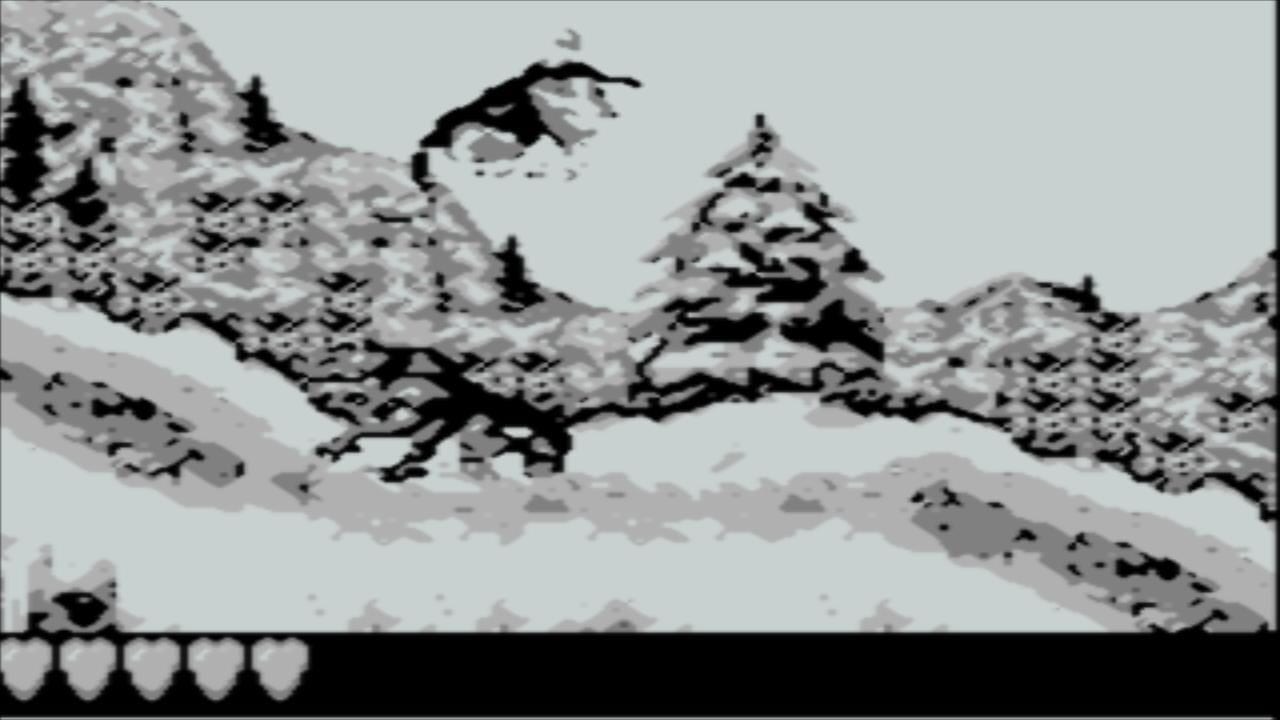 A monochrome Game Boy screenshot shows a snowy mountain landscape with snow-covered peaks and evergreen trees rendered in black and white pixels. A primate character with black coloring is positioned in the center-left area of the screen, leaping horizontally across the icy terrain. The sprite uses thick outlines typical of Game Boy graphics. At the bottom of the screen, a black UI bar displays five heart icons in white, representing the player's health meter. The background uses parallax layering with distant mountains appearing lighter and less detailed than foreground elements.
