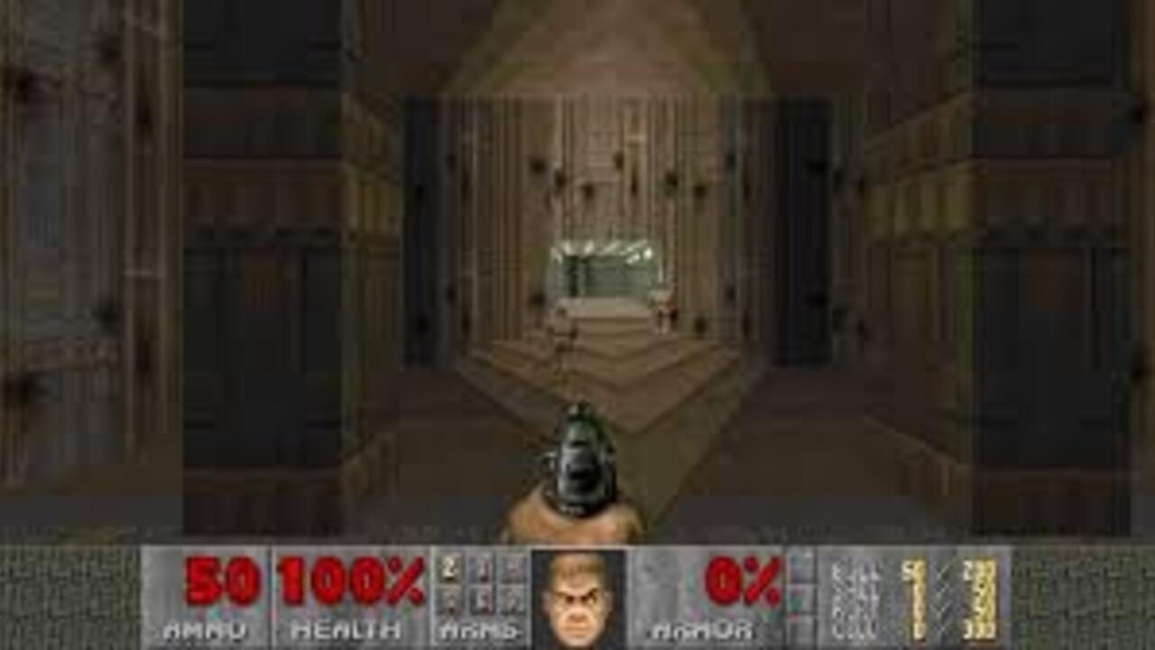 A first-person perspective view down a brown brick corridor with symmetrical doorways on both sides, rendered in low-resolution sprite graphics. A shotgun is visible in the lower-right corner of the screen. The bottom UI displays red health and ammo counters showing 50/100% health, a character portrait with an angry expression, 0% armor, and various weapon/item icons along the right side. The floor features a geometric pattern receding into the distance, with a small bright window visible at the corridor's far end.