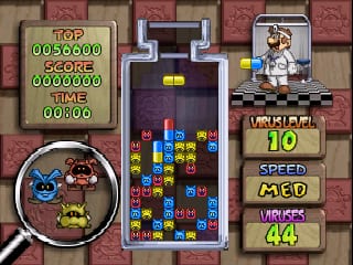 A Dr. Mario 64 gameplay screen displays the central falling-block puzzle grid with colored capsule pieces and virus blocks arranged mid-game. The top-left corner shows a green scoreboard reading "TOP 0050000 SCORE 0000000" with "TIME 0:00" below. On the right side, a vertical status panel lists "LEVEL 10", "SPEED X1.0", and "VIRUS 64" in wooden-framed boxes. A character portrait appears in the upper right corner, and a circular inset at bottom-left shows a zoomed view of the puzzle area. The overall aesthetic uses a tan and red wooden-paneled border with dark blue background for the game field.
