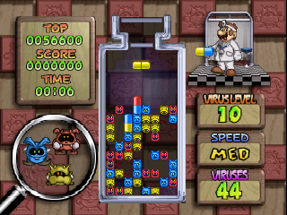 A Dr. Mario 64 gameplay screen displays the main play field in the center with colored blocks and viruses arranged vertically. The left side shows a circular character portrait featuring two mushroom creatures. The right panel displays game stats including a top score of 9060000, current score 0000000, time 00:00, level 10, speed M30, and lines 44. The art style uses bright primary colors with pixelated sprites typical of N64-era graphics. Decorative wooden-textured borders frame the entire interface with red fabric patterns in the background.