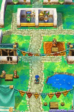 An overhead isometric view of a green outdoor town area with stone pathways, grass fields, and water. Multiple NPCs in colored clothing stand throughout the scene. Wooden bridges with green railings connect different sections. Buildings with brown roofs appear in the upper portion. A blue water body occupies the lower-right corner. The sprite-based graphics use a typical 16-bit RPG color palette with green dominating the landscape. Several characters are positioned near pathways and structures, suggesting an explorable town layout.