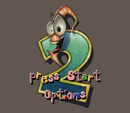 A cartoon earthworm character with large googly eyes and reddish-brown skin wears a yellow gun holster and blue belt, positioned left-center against a gray background. Below the character, the text "Press Start" appears in colorful pixelated letters with a gradient effect, followed by "Options" in smaller text. The character's exaggerated facial features and bright color palette are typical of early-to-mid 1990s SNES sprite graphics.
