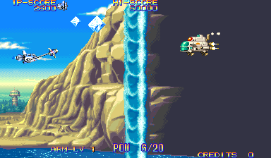 A side-scrolling shooter displays a desert cliff landscape with tan rocky formations and a bright blue waterfall on the right. Two player aircraft fly in the upper left against a blue sky with white clouds. Enemy sprites and projectiles appear scattered across the screen. The HUD shows level progression "LEVEL 1", player health "FULL 6/20", and credits count at the bottom. Pixelated 16-bit sprite graphics and parallax scrolling layers create depth in the sandy background and distant cityscape.