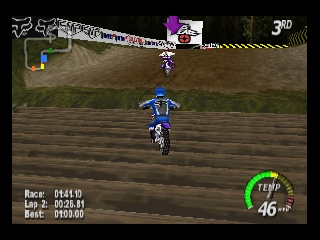 A blue motocross rider on a dirt bike races toward the camera on a brown terrain track. A purple rival rider appears ahead in the distance near a white barrier. The HUD displays race position, lap time 2028.61, best time 1759.60, and a green circular speedometer showing 46 mph in the lower right. The sky is dark with brown parallax hills in the background. Fox Racing and sponsor logos appear along the top of the screen in 3D rendered graphics typical of early 2000s Nintendo 64 games.