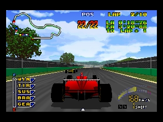 A red Formula 1 race car is shown from a rear-view perspective on a wide racing circuit with green grass barriers and distant hills under a blue sky with white clouds. The HUD displays position, lap count, and vehicle stats in the upper left corner; timer and speed information appear in the lower right. Pixelated trees and vegetation line the track edges in a 3D polygonal environment typical of N64-era graphics.