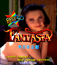 A young girl's face appears prominently in the center of the screen, smiling directly at the viewer. Above her is a colorful star-shaped logo with 'BEST 50' text. The word 'FANTASIA' is displayed in large orange letters below the star. Japanese characters appear in blue text beneath the title. At the bottom, copyright information reads '©1994 COMAD' with 'NEW JAPAN SYSTEM' and 'ALL RIGHTS' visible in small white text. The background shows warm brown and green tones. The overall aesthetic is characteristic of mid-1990s arcade game title screens with digitized photography combined with pixel-rendered graphics and text.