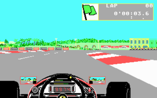 A first-person view from a Formula One car's cockpit shows the driver's hands gripping a black steering wheel at the bottom center. The track ahead displays gray asphalt with white lane markings curving to the right, red and white barriers along the edge, and a yellow building visible in the distant background. A cyan sky occupies the top portion. The HUD displays "LAP 00" and a time counter "0'00'03.6" in the upper right corner, with a small car icon showing position. Green grass and trees line the track edges, rendered in low-resolution pixels typical of 1989 DOS-era racing games. Two opponent cars appear as small colored vehicles on the track ahead.