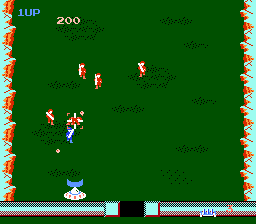 A green battlefield with a soldier sprite in the lower-left corner and multiple enemy soldiers scattered across the middle area. A decorative orange and yellow border frames the entire screen. The UI displays "1UP" and "200" in the top-left corner, with a health bar at the bottom showing blue segments. Black pixels mark section dividers on the bottom status bar. The NES-era sprites are small and blocky, rendered in bright primary colors against the solid green background.