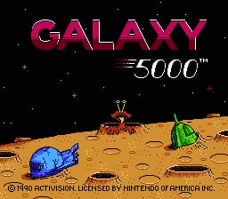 The title screen displays "GALAXY 5000" in large magenta letters at the top, with "5000™" in smaller white text. Below is a sandy desert landscape with scattered rocks and alien structures. A blue spaceship sits on the left side of the terrain, while a green dome-shaped structure appears on the right. Small white dots represent stars in the black sky above. Copyright text for Activision and Nintendo appears at the bottom of the screen.