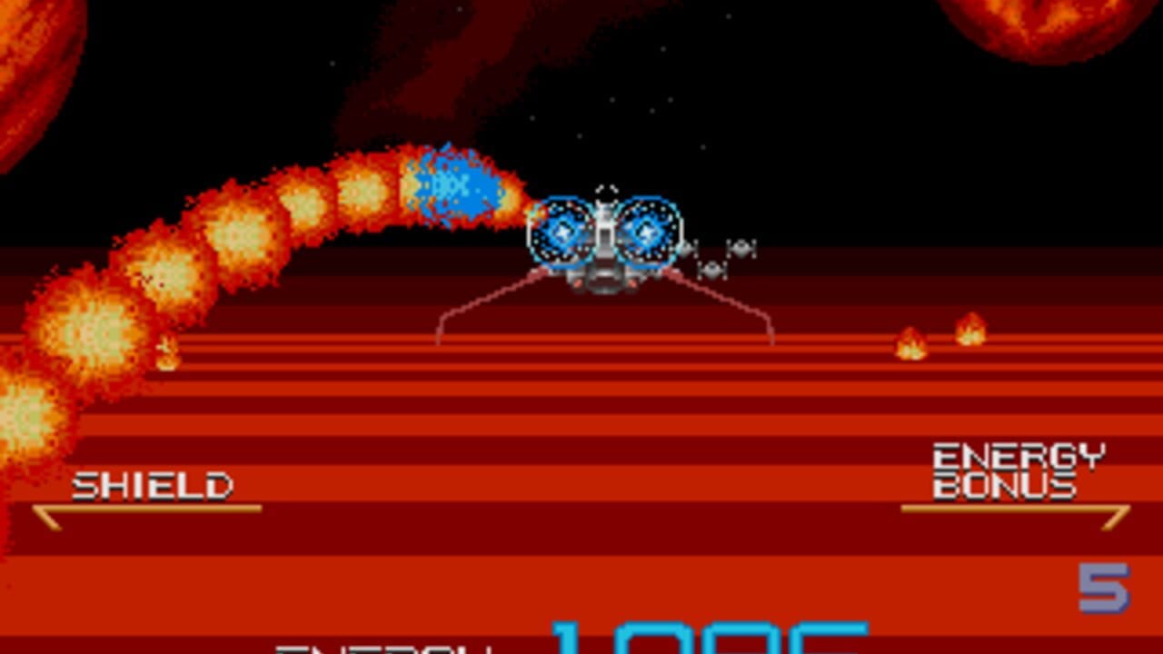 A spaceship with blue circular targeting reticles hovers above a red striped landscape dotted with small explosions. A curved arc of large fiery yellow and orange explosions detonates in the upper left, while smaller fire bursts scatter across the terrain. The HUD displays SHIELD and ENERGY BONUS bar indicators at mid-screen, with a blue score number 5 visible in the lower right corner. Black space with scattered stars fills the background above.