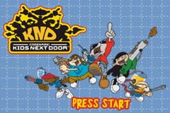 The title screen displays the Codename: Kids Next Door logo in yellow and black at the top left, with colorful cartoon characters arranged dynamically across the center against a light blue dotted background. Multiple child characters in various colored outfits pose in action stances, with orange and brown spheres scattered throughout the composition. A red "PRESS START" button appears prominently at the bottom center in pixelated font, typical of Game Boy Advance era graphics. The overall layout uses bright primary colors and sprite-based character designs characteristic of early 2000s handheld game presentations.