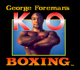 The title screen displays "George Foremans KO BOXING" in large yellow text at top and bottom. A photograph of George Foreman occupies the center, showing him shirtless with crossed arms. The image has a blue border frame and low-resolution pixel art styling typical of early 1990s Game Gear graphics. The background is solid black, with the text and photo framed by a simple rectangular border design.