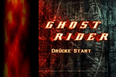 The title screen displays "GHOST RIDER" in large orange and yellow capital letters centered on a dark, textured background with red vertical streaks on the left side. Below the title, "Dducke Start" appears in smaller gold lettering. The overall color palette consists of dark grays, blacks, and warm orange-red tones, creating a gritty, high-contrast aesthetic typical of GBA-era sprite-based games. The background shows weathered, rough texturing suggestive of concrete or stone surfaces.