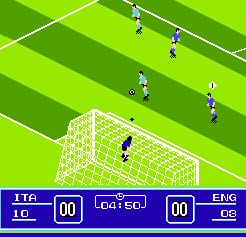 A soccer match viewed from above shows players in dark and light kits spread across a green striped field. A goalkeeper in white stands in the net at the center-bottom. The scoreboard at the bottom displays ITA 0-0 ENG with time 00:00, rendered in blue with white text. Players are positioned at various spots across the pitch, with the perspective showing the full width of the field and multiple depth layers indicated by alternating green shades.