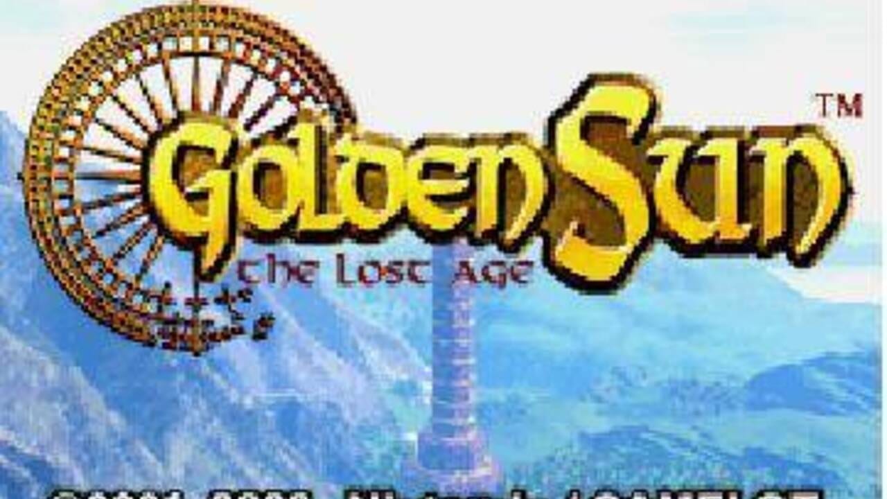 The Golden Sun II: The Lost Age title screen displays large yellow text with a TM symbol in the upper right. Behind the title, an ornate circular mechanical wheel or gear structure appears in the upper left, rendered in brown and gold tones. The background shows a mountainous landscape in blue and cyan hues with layered terrain visible through atmospheric perspective. At the bottom, partially visible text in dark lettering appears cut off. The overall art style uses 32-bit sprite graphics typical of Game Boy Advance titles.
