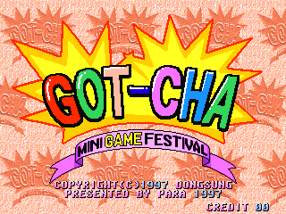 A bright title screen displays "GOT-CHA" in large, bold letters with yellow and red coloring, topped by yellow starburst shapes against a coral-pink patterned background. Below the title sits a purple banner reading "MINI GAME FESTIVAL." Copyright and developer information appears at the bottom in smaller white text, along with a credit counter showing "CREDIT 90" in the lower right corner. The overall design uses flat, blocky 1990s arcade aesthetics with high color saturation.