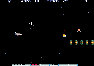 A black starfield backdrop hosts a white pixelated spaceship on the left side, facing right. Five golden enemy formations appear in the center-right area, with yellow geometric shapes arranged in groups. A horizontal status bar spans the bottom, displaying white text with game information including score, hi-score, and remaining lives. Small white geometric objects scatter across the playfield, representing projectiles or obstacles. The overall scene shows a typical vertical-scrolling shooter layout with minimal visual detail against the dark space backdrop.