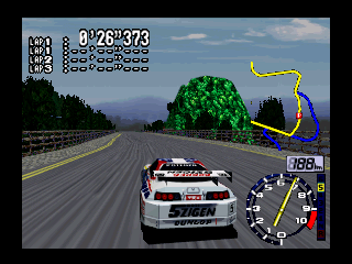A white racing car with red and black markings drives on an asphalt track in the center of the screen, viewed from behind. The road stretches toward a distant mountainous landscape under a blue sky with clouds. Tall green trees frame the right side of the track, and a yellow racing line curves across the road ahead. The upper left displays lap time and race statistics in white text. A minimap with directional arrow and speed indicator occupies the lower right corner. The 3D rendered environment shows flat-shaded terrain with pixelated distant mountains characteristic of N64-era graphics.