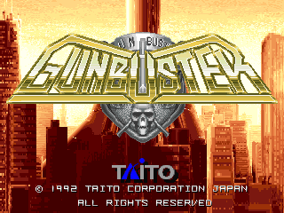 The Gunbuster title logo appears centered in large metallic lettering with a winged emblem above it, set against a golden-yellow sky with silhouetted city buildings in the background. Below the logo, the Taito Corporation copyright notice and Japan attribution are displayed in white text. The art style uses a warm color palette of golds and oranges with red-toned architecture, typical of early 1990s arcade title screens.