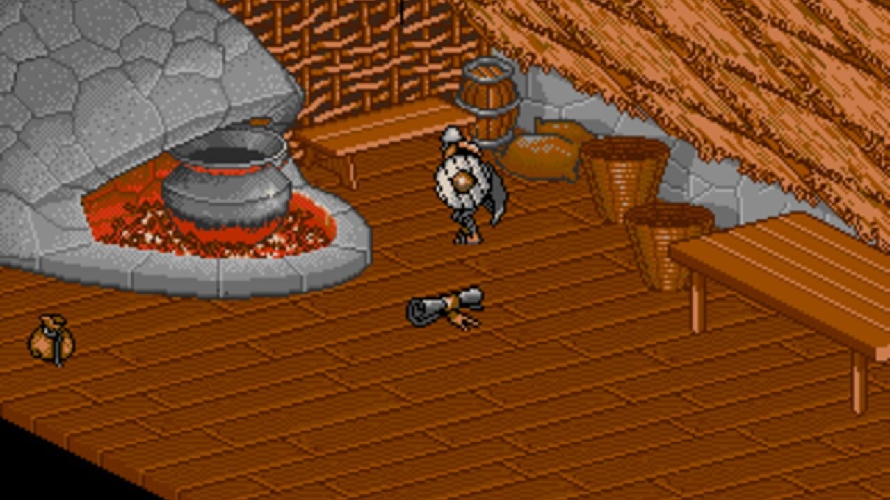 A wooden interior room with stone walls and a thatched roof displays a small character figure standing centrally on the brown floor. A fireplace with glowing red coals and a metal cauldron sits against the left wall, while wooden crates, barrels, and structural posts populate the right side. A small animal or creature appears in the lower-left corner. The isometric perspective shows typical 16-bit pixel art styling with a warm brown and gray color palette.