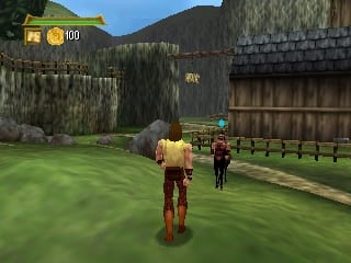 A player character in tan and brown clothing stands in a grassy courtyard with two NPCs nearby. A gray elephant is visible in the middle distance. Wooden buildings with tiled roofs and stone walls frame the scene on the left and right. Mountains and trees fill the background. A health bar showing 100 appears in the upper left corner. The 3D environment uses flat-shaded polygonal models with a limited color palette typical of early Nintendo 64 graphics.
