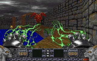 A first-person dungeon view displays two green-outlined demonic creatures with red accents facing the player in a stone brick corridor under a dark sky. The HUD at the bottom shows a centered crosshair, ammunition counter reading 200 on each side, inventory slots, and health/mana bars. Brownish terrain and blue water are visible in the mid-ground, with brick walls and structures receding into the background. The color palette uses muted browns, grays, and blues with bright green enemy highlights typical of early 1990s software-rendered 3D graphics.