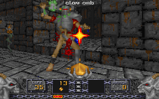 A player character wielding a glowing staff faces a large demonic enemy in a stone brick corridor. Bright yellow-white explosive effects burst from the center of the combat. The HUD spans the bottom of the screen with a gray metallic border, displaying health at 13, armor at 45, and various weapon and item icons arranged across a dark background. Stone pillars and archways form the dungeon architecture in the background. The sprite-based graphics use muted earth tones and yellows characteristic of mid-1990s DOS games.