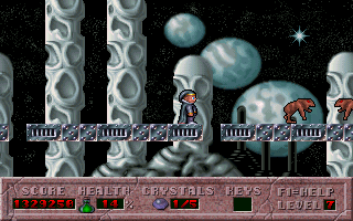 A wizard character stands on a stone platform amid gray cylindrical columns and floating rocky terrain against a starry black background. The sprite-based protagonist wears red robes and is positioned center-left. Two large gray planets or spheres loom in the upper-middle area. A purple status bar spans the bottom of the screen displaying score, health, crystals collected, and level information in pixelated text. The visual style uses low-resolution pixel art with a limited color palette of grays, blues, reds, and blacks typical of early DOS platformers.