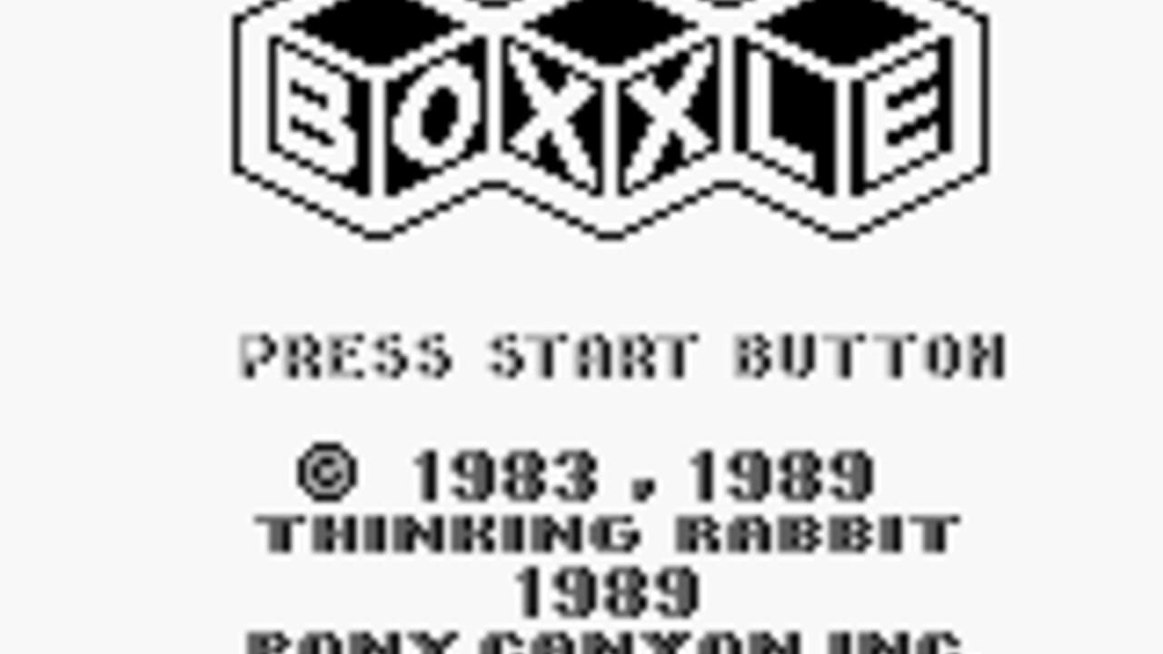 The Boxxle title screen displays an isometric logo with three three-dimensional cube-like boxes at the top. Below it reads 'PRESS START BUTTON' in pixelated monospace font. Copyright information shows © 1983, 1989 Thinking Rabbit 1989, with partial text 'ROMMY COMPANY INC' visible at the bottom. The screen uses black text on a light gray background typical of Game Boy-era graphics.