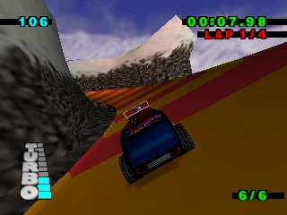 A red Hot Wheels car races along a dirt track with a snow-capped mountain visible in the background. The car is positioned in the center-right of the screen, viewed from behind. The track curves ahead with gray cliff walls on the left and tan-colored terrain on the right. The HUD displays lap time 00:07:93 in the top-right corner, a score of 6/6 in the bottom-right, and remaining fuel or health in the bottom-left. A minimap appears in the lower-left corner showing the track layout. The sky features blue and white clouds above the mountain terrain.