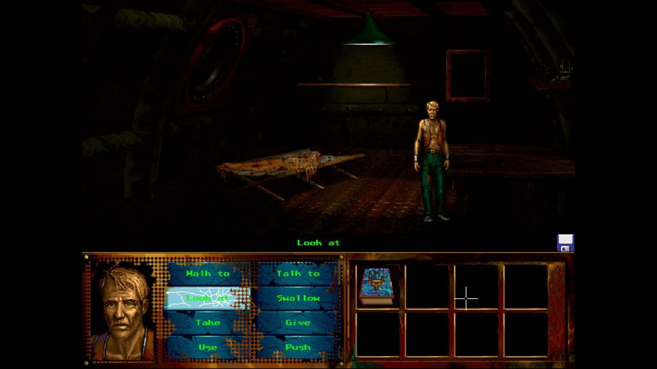 A character in a tan shirt and green pants stands in a dark industrial room with corroded metal surfaces and hanging pipes. A rusted elongated object lies on the ground to the left. The bottom interface displays a character portrait on the left, green text action verbs in the center (Walk to, Talk to, Take, Use, Look at, Swallow, Give, Push), and an inventory grid on the right showing one small illustration. The scene uses muted earth tones against heavy shadows typical of early 1990s point-and-click adventure game graphics.