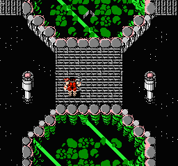 A top-down view of two connected fortress levels with gray stone walls and green foliage. A red-clad soldier character stands on the middle platform between the upper and lower areas. Two tall gray guard towers flank the sides. Green leafy vines and rock formations border the top and bottom of the screen against a black background. The pixelated sprite-based graphics use a limited color palette typical of NES-era games.