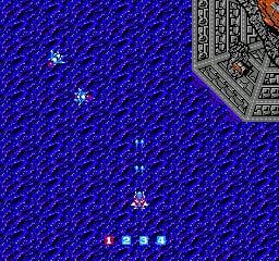 A space shooter scene displays a blue textured background resembling water or energy waves, with a gray pixelated structure visible in the upper right corner. A small white player ship is centered in the lower portion of the screen, with four white projectiles aligned horizontally below it. Several white enemy ships are scattered across the blue field at various positions. The visual style uses a limited NES-era color palette of blue, white, and gray with characteristic low-resolution sprites and tile-based construction.