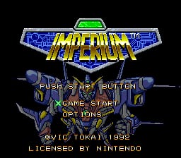 The title screen displays "IMPERIUM" in large yellow capital letters centered at the top, with blue metallic wing-like design elements flanking it on both sides. Below the title, two armored robotic figures stand symmetrically on either side of the screen against a dark background. Menu text reads "PUSH START BUTTON" and "GAME START OPTIONS" in the center. At the bottom, copyright text states "©VIC TOKAI 1992" and "LICENSED BY N.INTENDO." The overall color scheme uses blue, yellow, and dark tones typical of early 1990s SNES graphics.