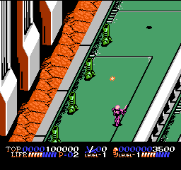 A soldier character stands in the center of a green battlefield with two tanks positioned on either side. An orange brick wall with white stripes forms a diagonal divider on the left edge. The HUD displays health, score (10000), level number (2), and remaining lives (2500) across the top in white text against a dark background. The sprite-based graphics use a limited NES color palette with olive green grass, orange and white brick patterns, and pixelated military vehicles rendered in 8-bit style.