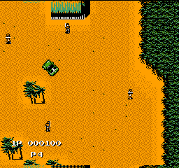 A top-down military jeep action game displays an orange desert terrain with dark green forest at the right edge. A player-controlled jeep with visible gun turret occupies the lower-left, flanked by score display "000100" and remaining lives counter showing two jeeps. Four enemy soldiers in green stand scattered across the sandy expanse. Sprites use 8-bit pixel art style typical of late-1980s NES hardware.