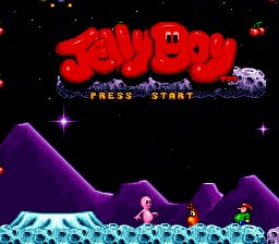 The Jelly Boy title screen displays the game's logo in large red pixelated letters at the top center against a black starry background. Below the title, yellow text reads "PRESS START". The lower half shows a purple and magenta mountainous landscape with several small character sprites scattered across the terrain in cyan, pink, and green colors. A small purple vehicle sprite appears on the right side of the landscape. The overall color palette uses bright neon hues typical of early 1990s SNES graphics.