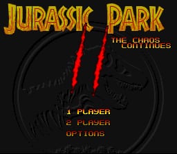 The title screen displays "JURASSIC PARK" in large gold letters at the top, with "THE CHAOS CONTINUES" in smaller red text below. A stylized dinosaur skull rendered in dark grays and blacks occupies the center of the screen, with two red vertical lines crossing through its eye sockets. Below the skull, menu options in orange text read "1 PLAYER," "2 PLAYER," and "OPTIONS" aligned to the left. The background is black with a grid pattern visible beneath the skull graphic, characteristic of 16-bit SNES-era graphics.