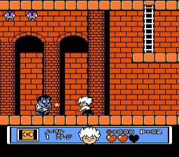 A young vampire character stands in the center of a brick chamber with two tall arched doorways on either side. Red brick walls fill the background, with a white ladder visible on the right edge. Two bat-like enemies hover in the lower portion of the screen. At the bottom, a blue HUD bar displays health, item icons, and a power meter with orange and white segments against the orange-brick game environment rendered in 8-bit pixel art.