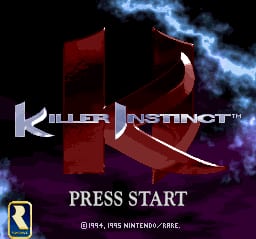 The Killer Instinct title screen displays the large white serif logo in the center, overlaid on a stylized red and purple abstract shape against a black background with blue lightning effects. Below the logo, "PRESS START" appears in white text, followed by controller input notation "[R]+4, HNS NINTENDO/ABS5" in smaller text at the bottom. A Rare Ltd. developer logo is visible in the lower left corner. The overall composition uses a dark palette with neon-colored accents typical of mid-1990s fighting game presentation.