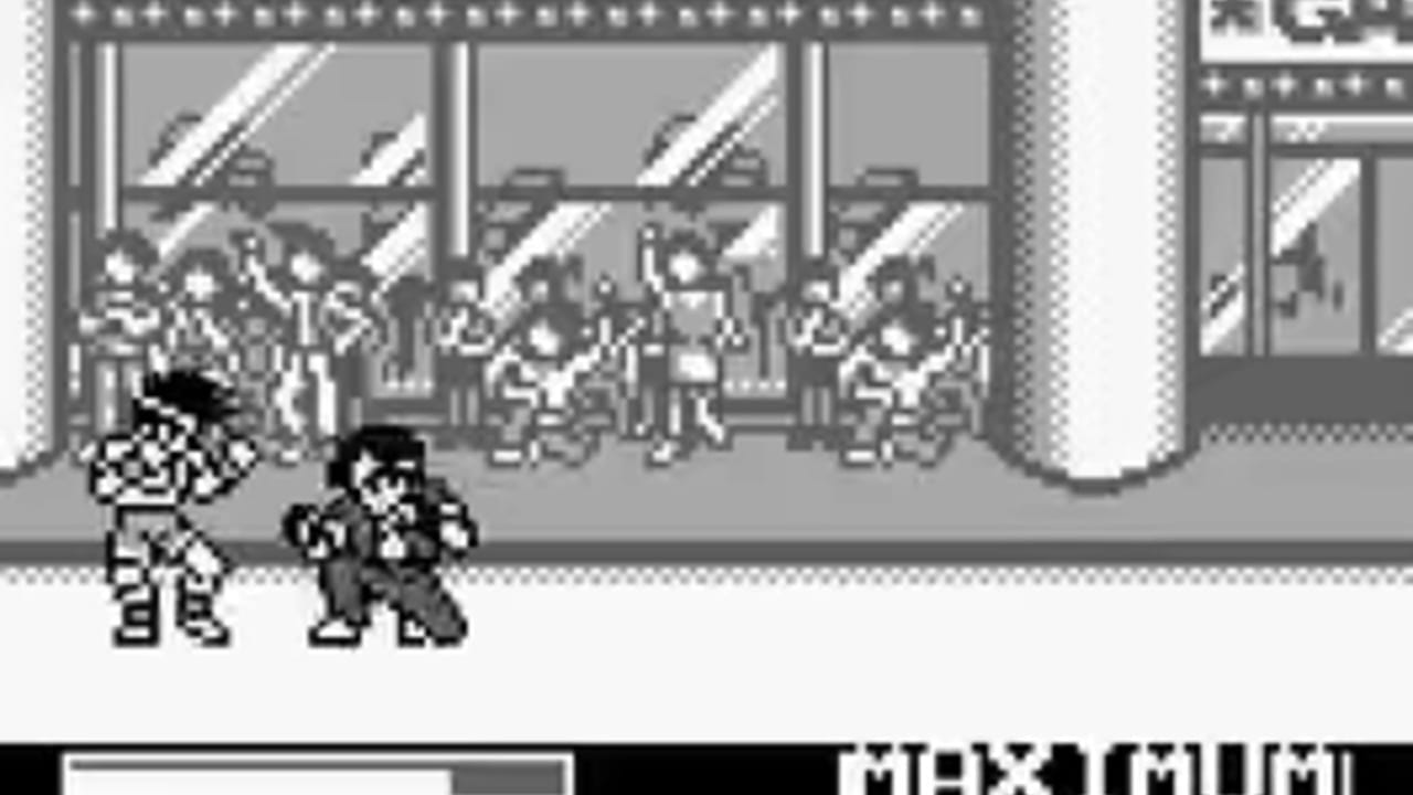 Two pixelated fighters stand in the foreground of an indoor venue with large windows showing a crowd of spectators in the background. The left character wears a patterned outfit while the right character is dressed in dark clothing. The scene uses grayscale monochrome rendering typical of Game Boy hardware, with sharp sprite outlines and minimal color variation. Large cylindrical support columns frame the sides of the indoor setting, and angular window panes with bright highlights dominate the upper portion of the screen.