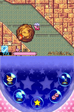 The screen is split horizontally, showing the top half as a brick-walled level interior with Kirby in pink, a rotating golden bomb-like object, and an enemy with a pink appearance. The bottom half displays a blue treasure chest or menu interface with seven circular slots containing various collectible items: a yellow star in the center, surrounded by six other orbs with different colored icons and symbols. A health bar appears in the upper left of the gameplay section. The pixel art uses vibrant reds, yellows, blues, and pinks typical of the Nintendo DS color palette.