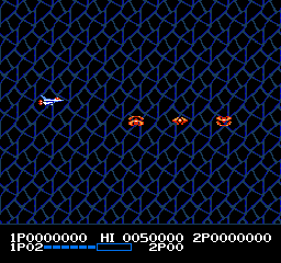 A horizontal scrolling shooter displays a blue mesh background with three orange enemy ships centered on screen. The player's white ship appears in the upper left. Hexagonal grid patterns fill the playfield in dark blue and black. At the bottom, a status bar shows score readouts, health meter in blue, and enemy indicators, with the HUD text in white and light blue against the dark background.