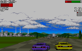 Two racing cars—one purple and one yellow—are positioned on an asphalt track in the foreground, facing right. A large industrial complex with tall blue and red smokestacks dominates the middle ground to the left. Green grass fields and trees border the track, with a multi-layered sky featuring blue patches and white clouds. A health bar and lap counter appear in the top-left corner, with a gear indicator in the top-right. The graphics use a Mode 7-style perspective common to early 1990s racing games, with visible pixelation and a limited color palette typical of DOS-era sprite rendering.