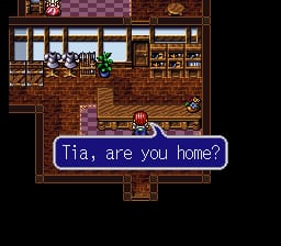 A dialogue box with blue border displays "Tia, are you home?" at the bottom of an indoor room. The room features wooden furniture including shelves, cabinets, and a table with checkered flooring and brick walls. A character sprite stands in the center of the room, rendered in 16-bit pixel art style typical of SNES graphics. The overall color palette consists of browns, reds, and darker tones characteristic of early 1990s RPG aesthetics.