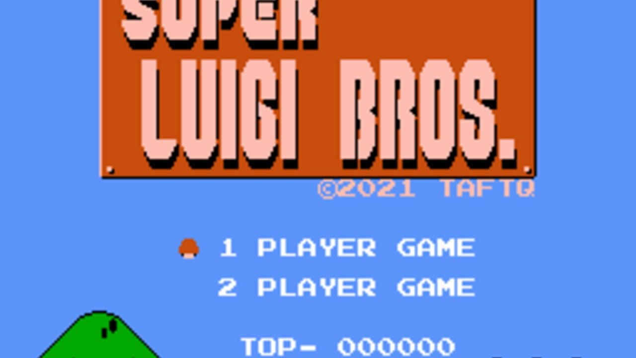 A blue background displays the Super Luigi Bros title screen with an orange banner at top. Below, menu options show "1 PLAYER GAME" with a red character sprite icon selected, and "2 PLAYER GAME" unselected. A score display reads "TOP- 000000" at bottom. A green pixelated hill sprite appears in the lower left corner. The copyright notice shows "©2021 TAFTO" in light blue text.