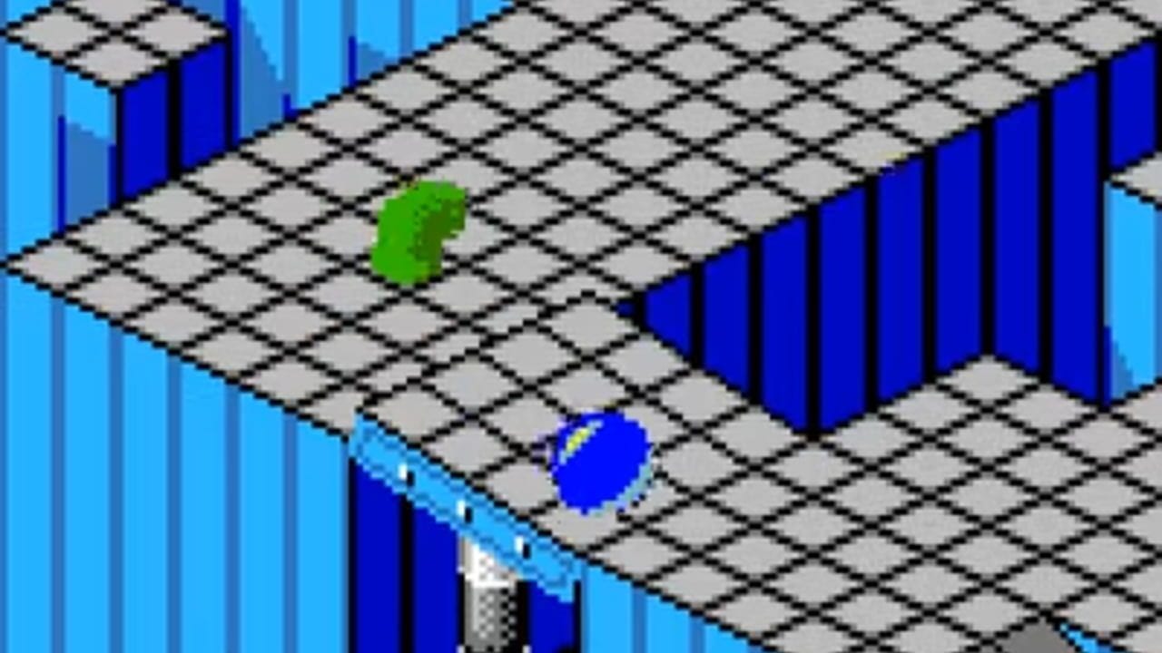An isometric-perspective gameplay view showing a gray and black checkered floor with blue walls forming an enclosed chamber. A bright green marble sits in the upper-center area, while a blue marble with yellow detail is positioned lower on the floor. The scene uses flat shading and simple geometric shapes typical of early 8-bit graphics, with a light blue sky visible through the open architecture.
