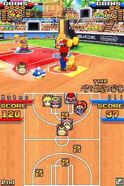 A split-screen view of Mario Hoops 3-on-3 gameplay on Nintendo DS. The top screen displays an overhead basketball court with Mario characters positioned around a red ball near the basket, with crowd stands and scoreboard visible in the background. The bottom screen shows a tactical court map with player icons, a score of 120 displayed on the left side, and team roster information on the right. The interface uses bright colors with orange court flooring and blue UI elements typical of early DS basketball games.