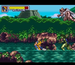 A yellow-armored character stands in shallow water amid tropical vegetation, facing right toward rocky terrain. A blue health bar and character portrait appear in the upper left corner. The background shows a blue sky with green foliage and brown rock formations. An enemy figure with a rounded shape sits on the upper right platform. The scene uses a 16-bit SNES color palette with parallax scrolling evident in the layered vegetation and water effects.